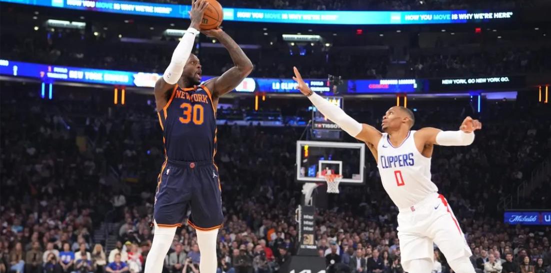 Randle (30) shoots despite the efforts of Clippers guard Russell Westbrook